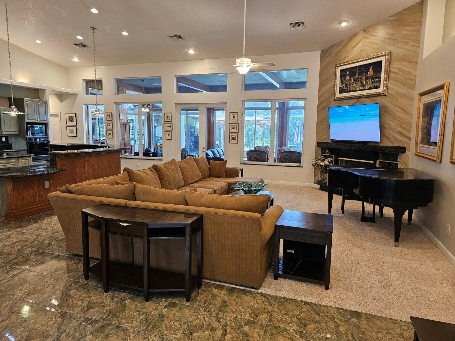 6963 Wilson Road West Palm Beach, FL 33413 - Photo 4 of 29 a living room with furniture a fireplace and a flat screen tv