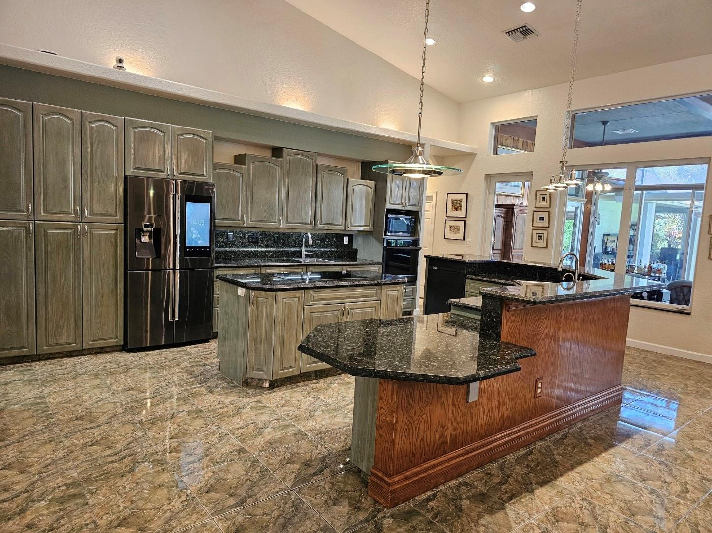 6963 Wilson Road West Palm Beach, FL 33413 - Photo 7 of 29 a kitchen with stainless steel appliances granite countertop a stove and a refrigerator