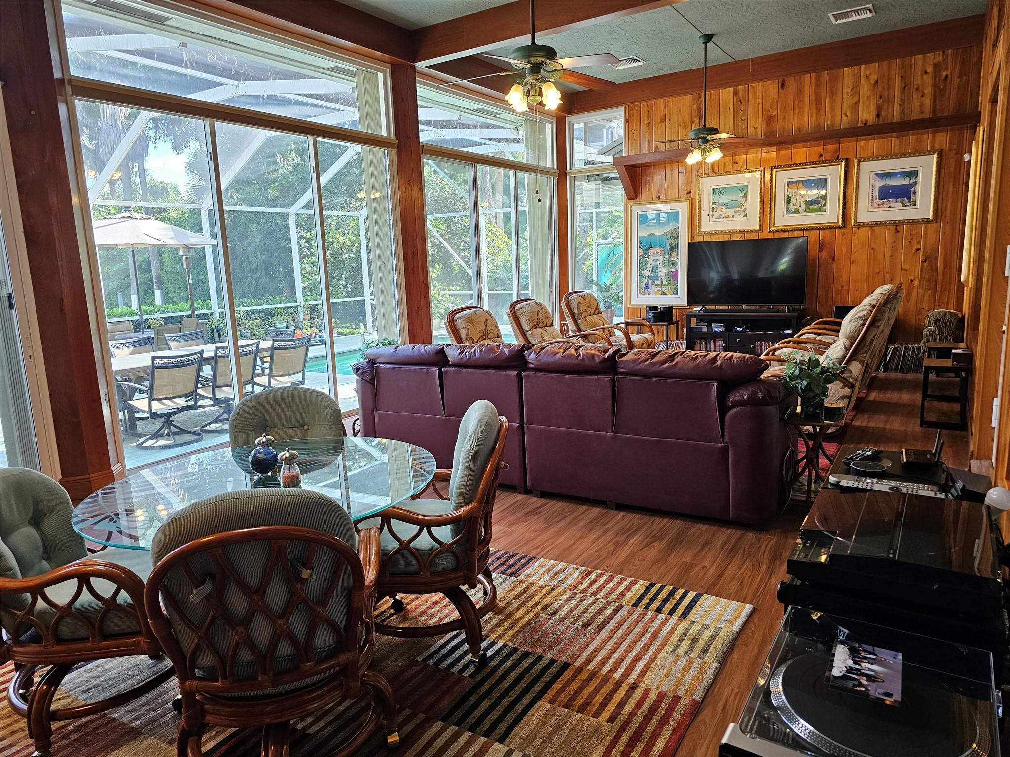 6963 Wilson Road West Palm Beach, FL 33413 - Photo 8 of 29 a living room with furniture a flat screen tv and a floor to ceiling window