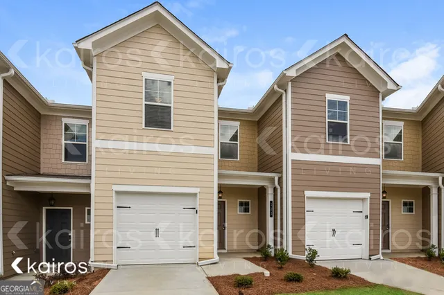 a front view of a house with a parking space