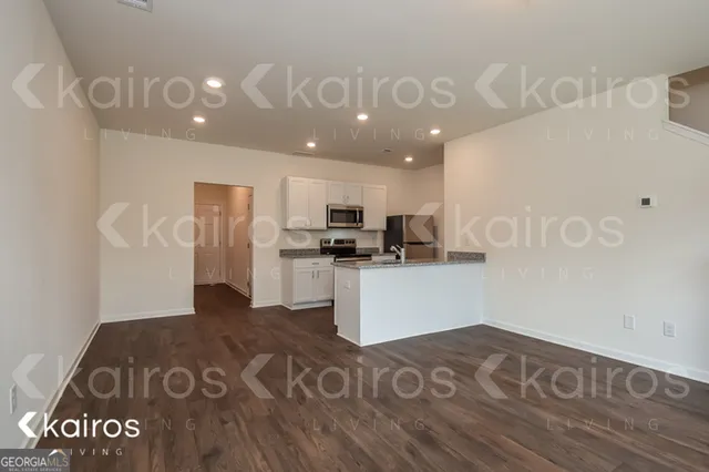 a kitchen with a refrigerator and a stove