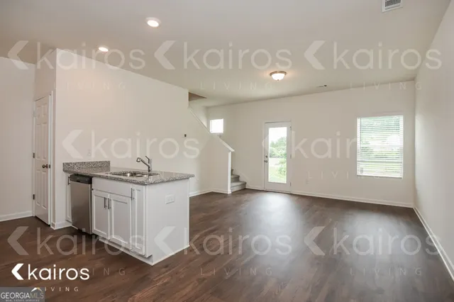 a kitchen with granite countertop a stove and a sink