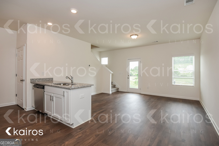 123 Dudley Way Cartersville, GA 30120 - Photo 6 of 16 a kitchen with granite countertop a stove and a sink