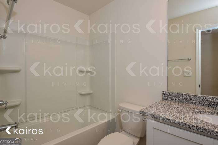 123 Dudley Way Cartersville, GA 30120 - Photo 9 of 16 a bathroom with a granite countertop sink and a mirror