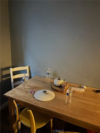 a view of a dining room that has a table and chairs