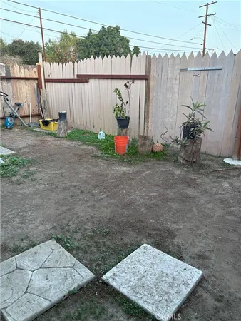 a view of a backyard with plants and a small yard