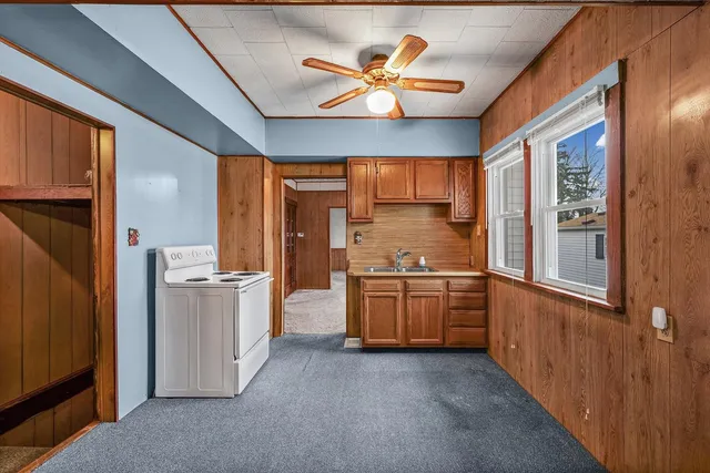 a kitchen with stainless steel appliances granite countertop a refrigerator a sink dishwasher a stove with cabinets and wooden floor