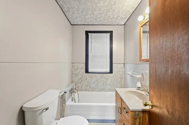 a bathroom with a sink a toilet and tub