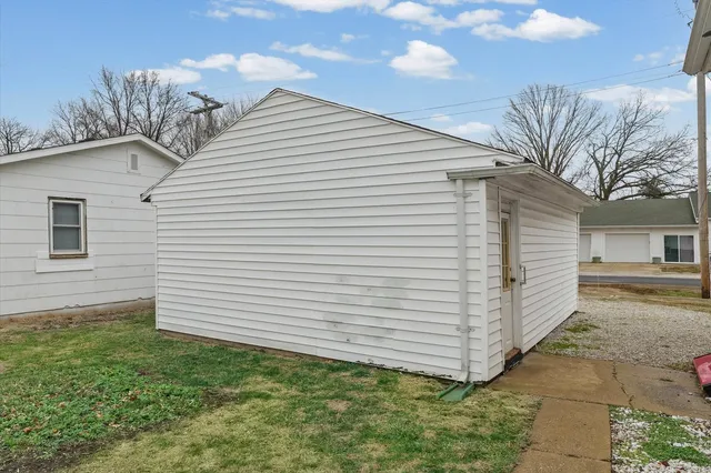 a view of a white house with a large space
