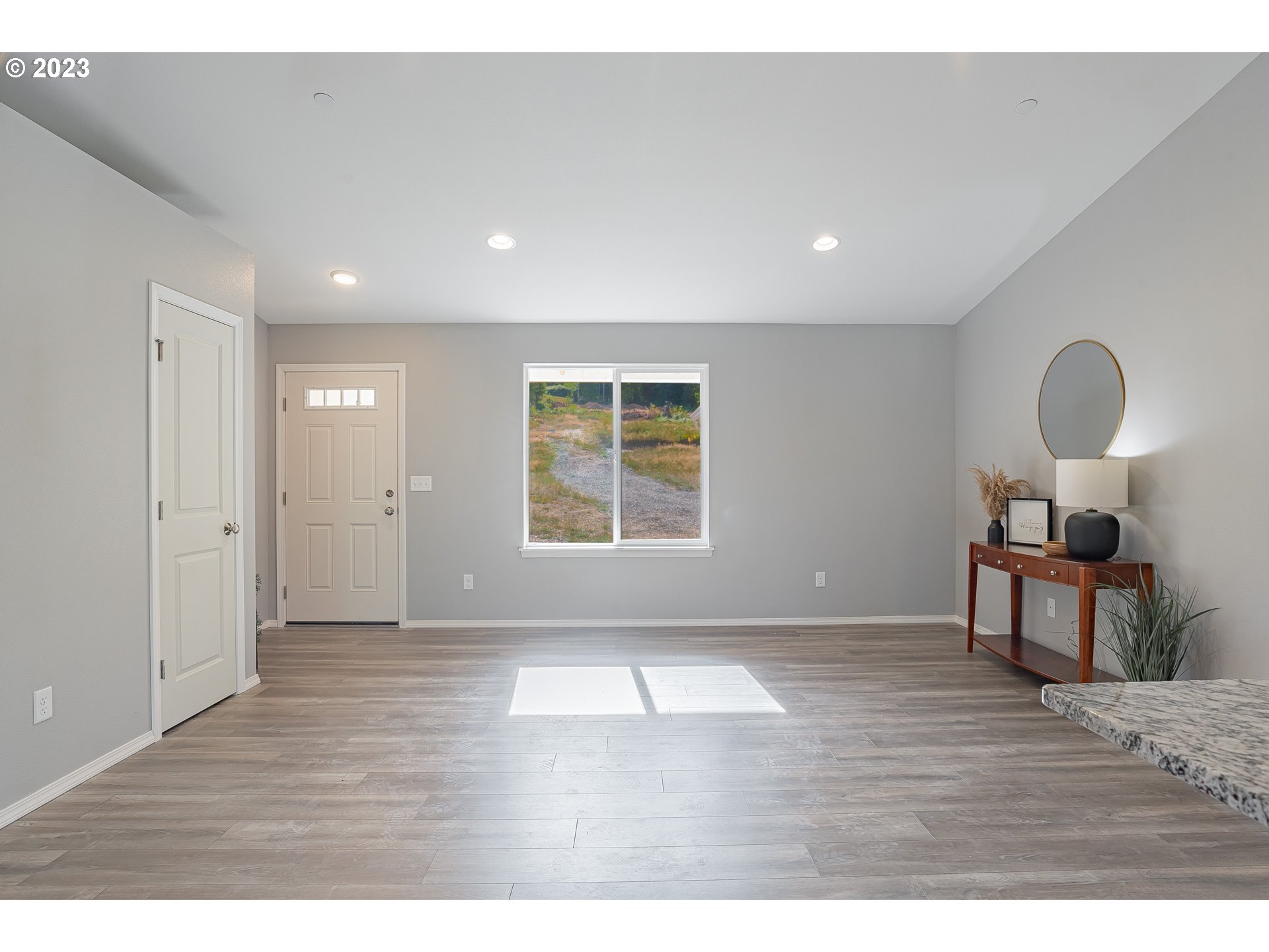 501 Hooper Road Longview, WA 98632 - Photo 3 of 28 a view of an empty room with wooden floor and a window