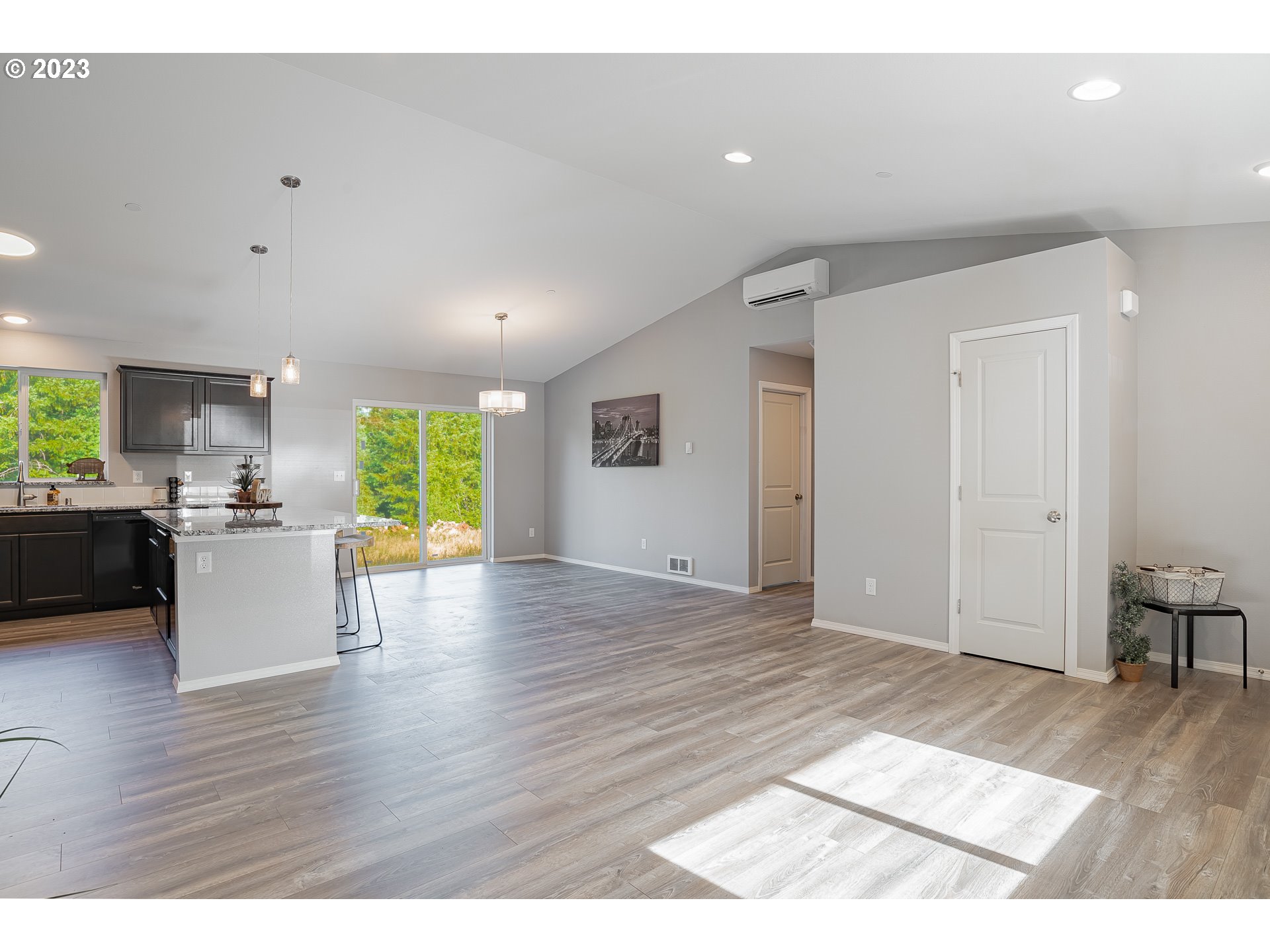 501 Hooper Road Longview, WA 98632 - Photo 5 of 28 a view of an empty room and kitchen with wooden floor