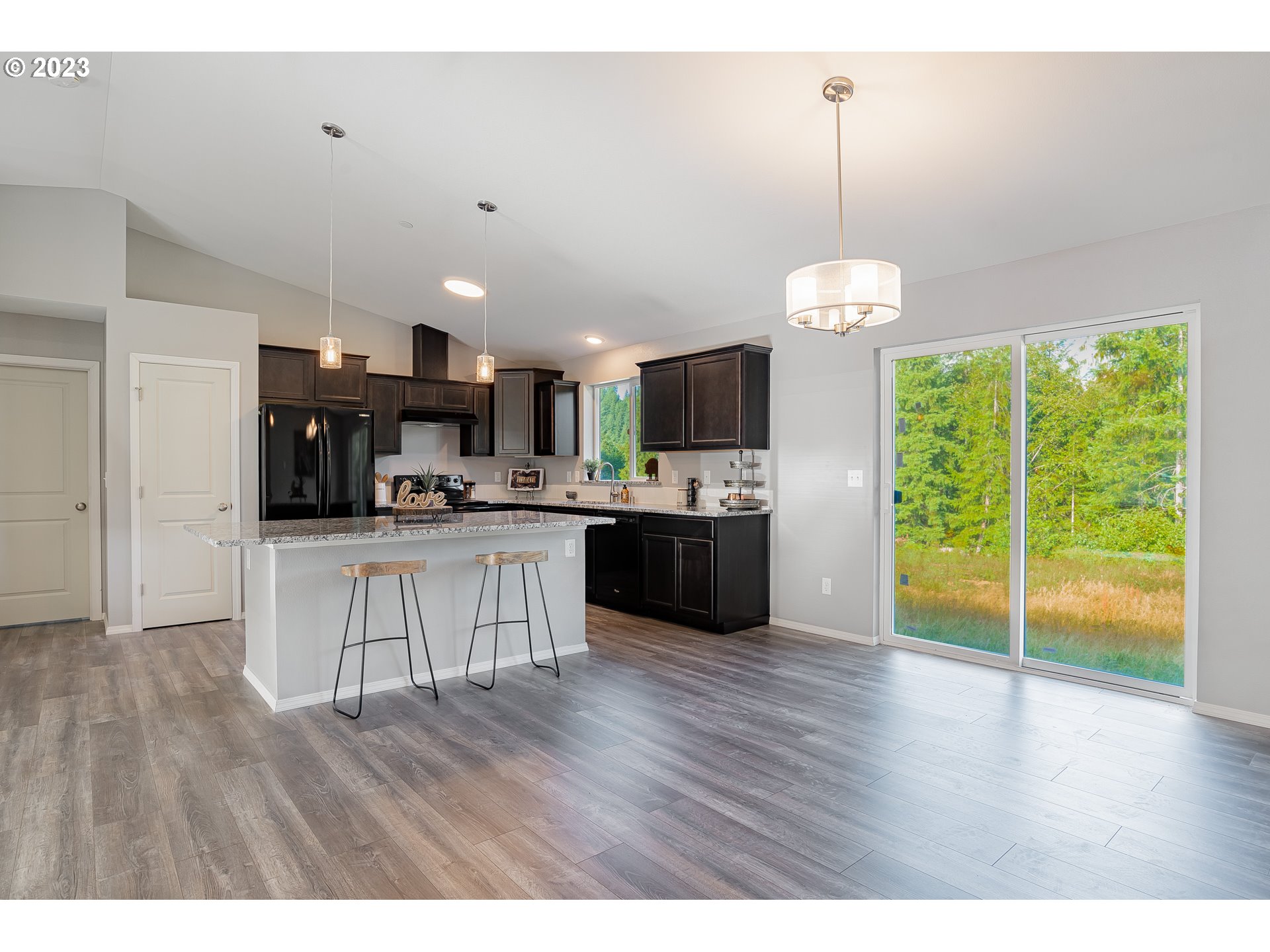 501 Hooper Road Longview, WA 98632 - Photo 6 of 28 a open kitchen with stainless steel appliances granite countertop a refrigerator a sink dishwasher a stove and white cabinets with wooden floor