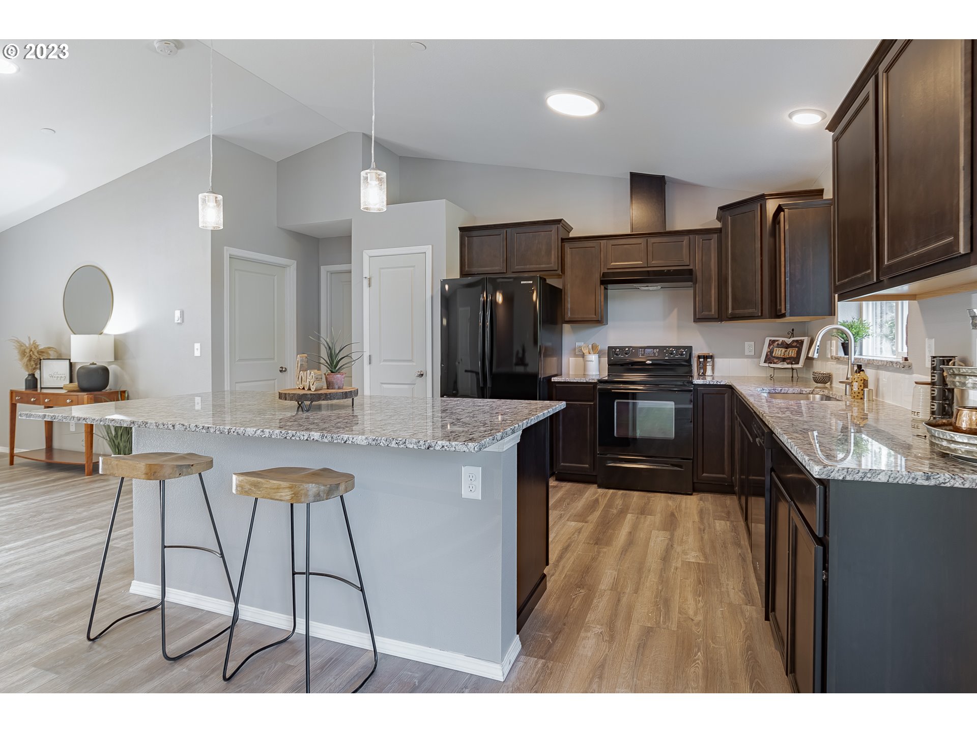 501 Hooper Road Longview, WA 98632 - Photo 7 of 28 a kitchen with stainless steel appliances kitchen island granite countertop a sink refrigerator and cabinets