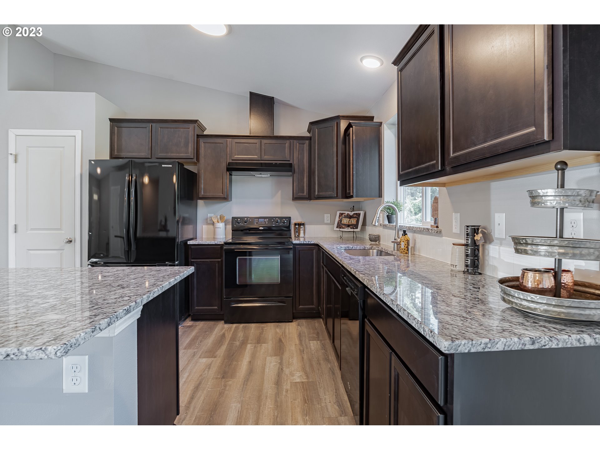 501 Hooper Road Longview, WA 98632 - Photo 8 of 28 a kitchen with stainless steel appliances granite countertop a sink refrigerator and microwave