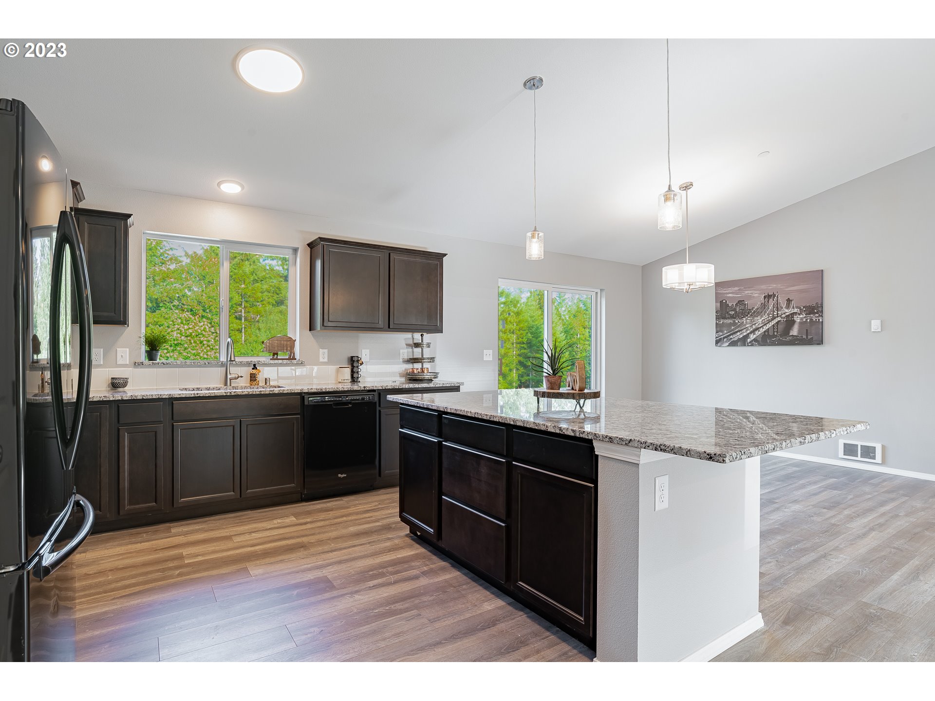 501 Hooper Road Longview, WA 98632 - Photo 10 of 28 a kitchen with stainless steel appliances kitchen island granite countertop a sink and wooden cabinets