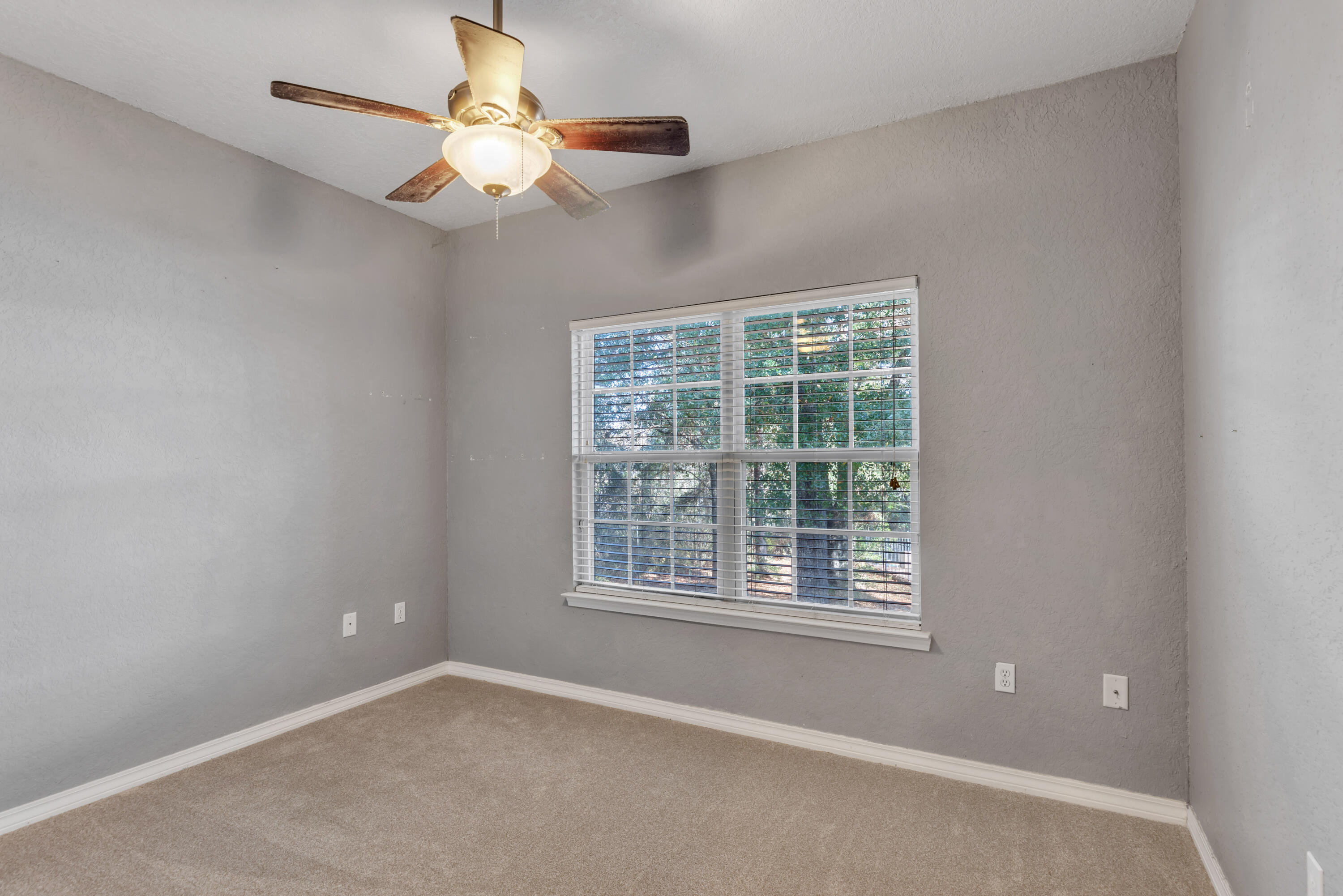 109 Oakcrest Drive Crestview, FL 32539 - Photo 17 of 35 an empty room with a window and a fan