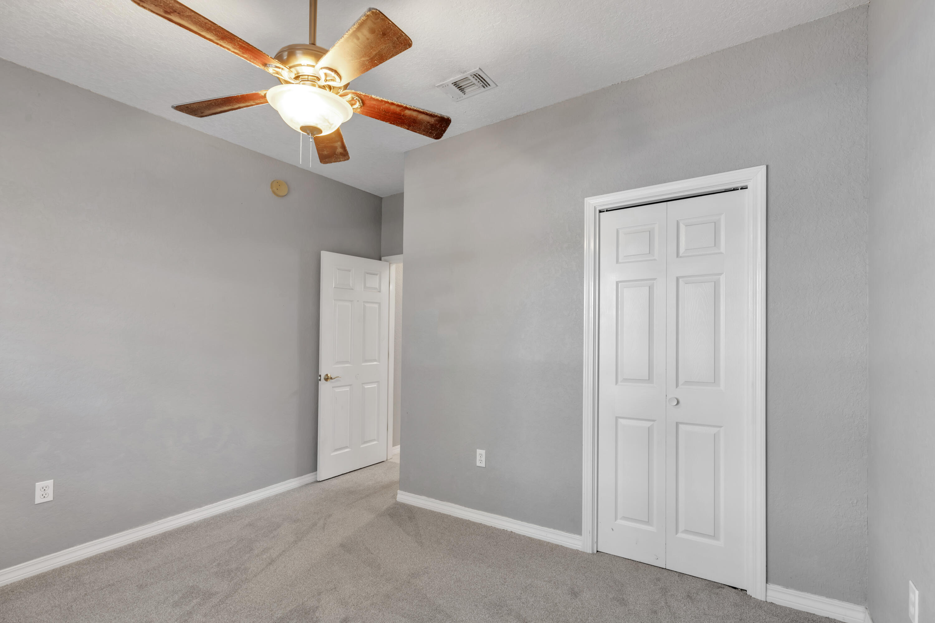 109 Oakcrest Drive Crestview, FL 32539 - Photo 19 of 35 an empty room with closet and a chandelier fan