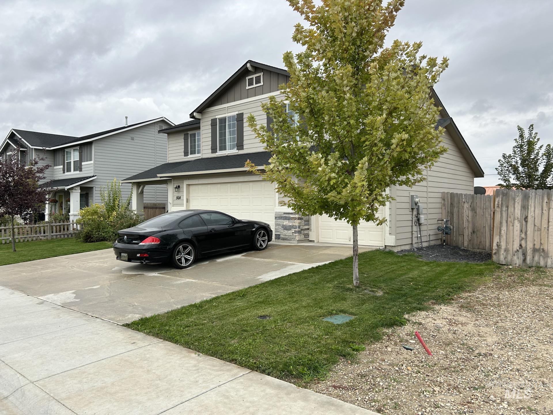 5614 Barkley Way Caldwell, ID 83607 - Photo 2 of 50 View of front of property featuring an attached garage, board and batten siding, and driveway