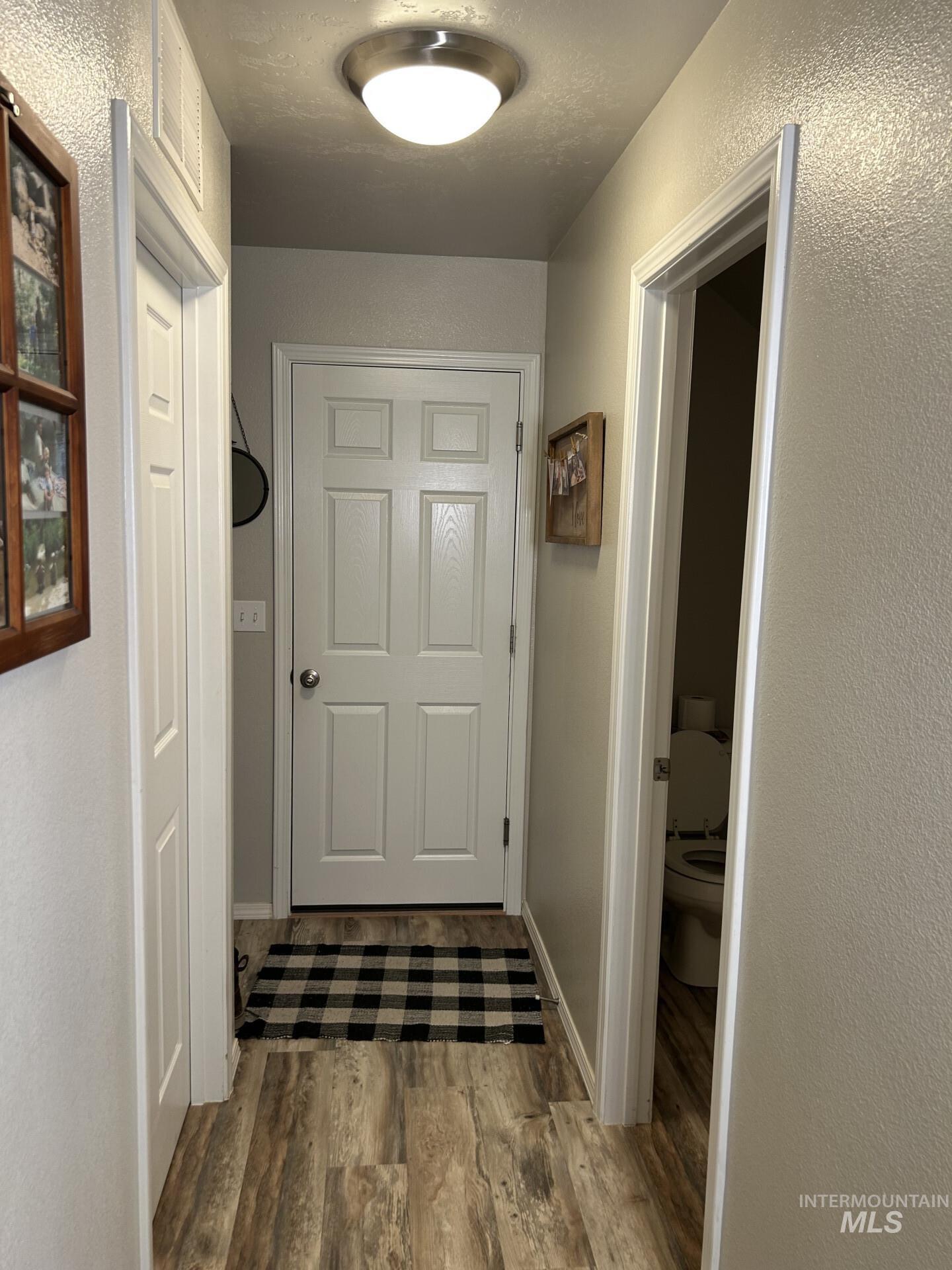 5614 Barkley Way Caldwell, ID 83607 - Photo 25 of 50 Corridor with a textured wall and light wood-style flooring