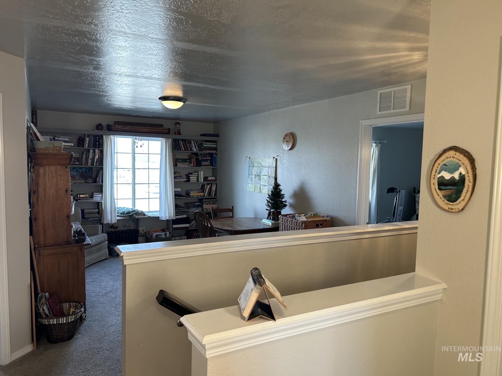 5614 Barkley Way Caldwell, ID 83607 - Photo 29 of 50 Kitchen featuring carpet, a textured ceiling, and a textured wall