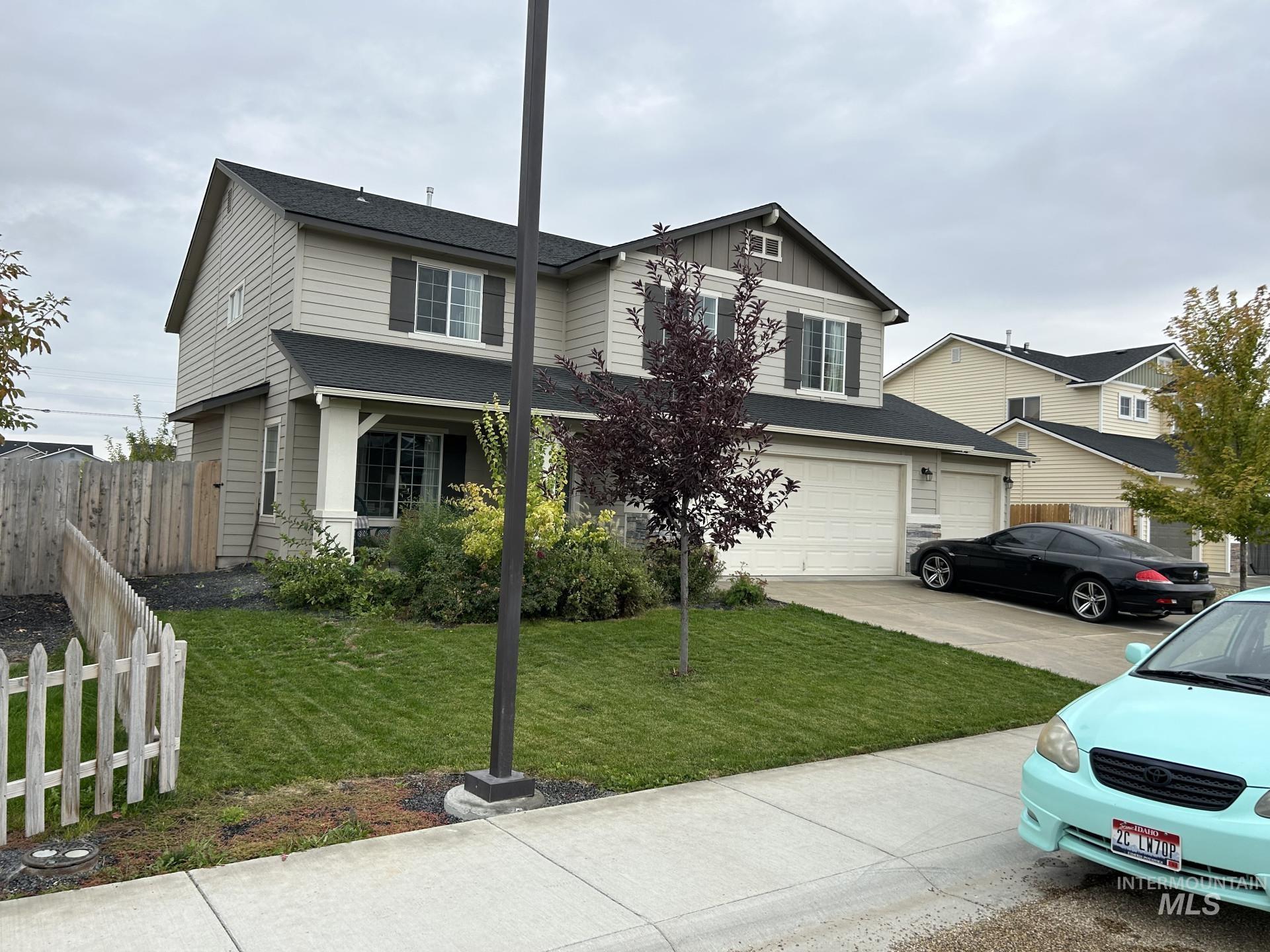 5614 Barkley Way Caldwell, ID 83607 - Photo 3 of 50 Traditional home with a garage, concrete driveway, board and batten siding, and a shingled roof