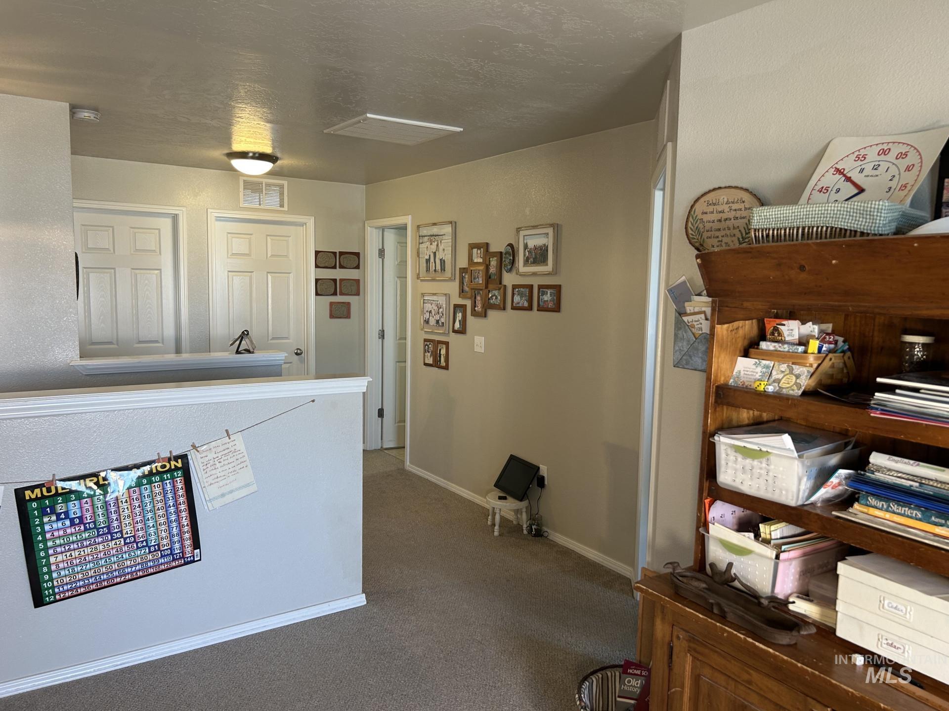 5614 Barkley Way Caldwell, ID 83607 - Photo 31 of 50 Hall with carpet flooring and a textured ceiling