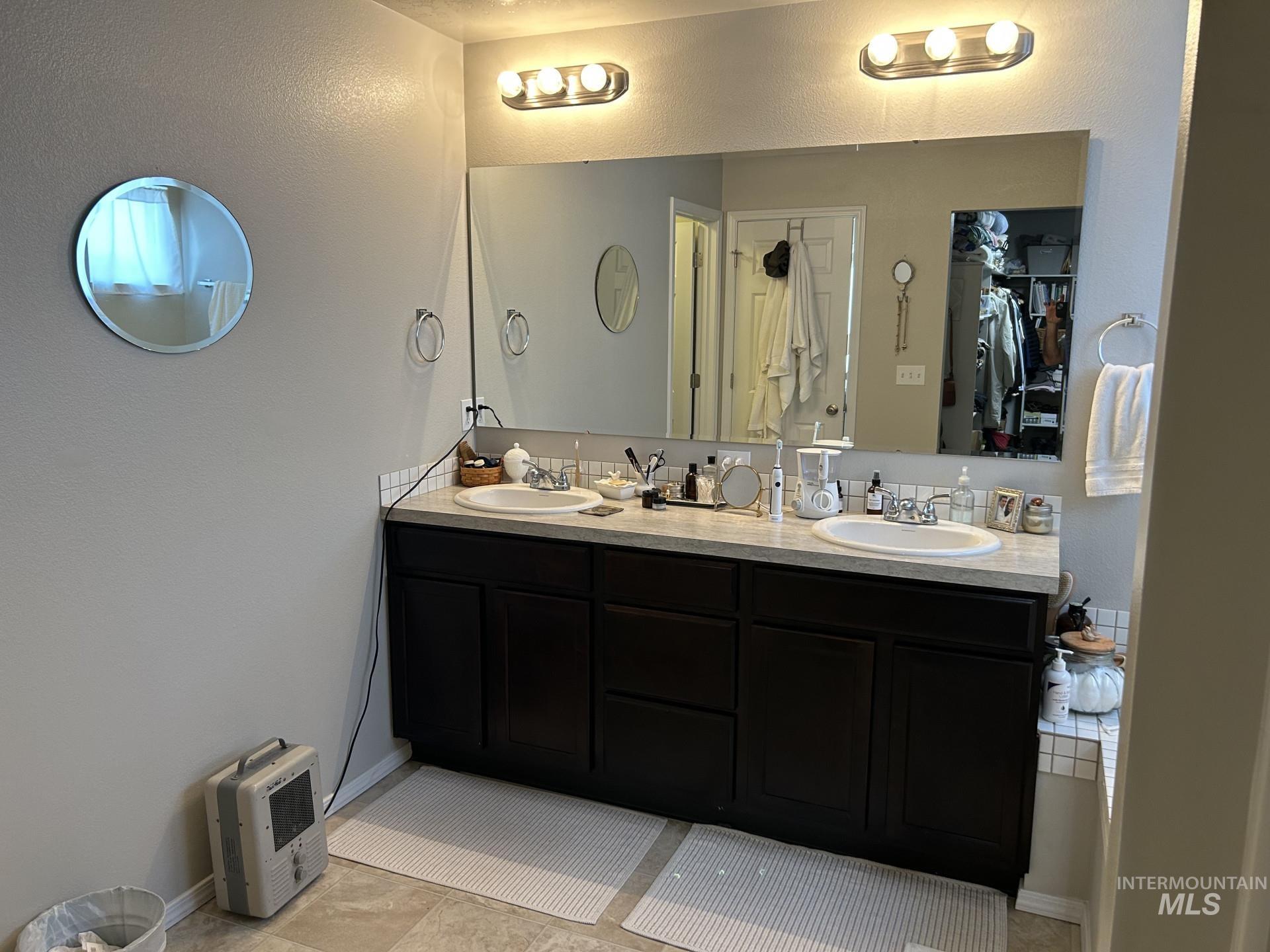 5614 Barkley Way Caldwell, ID 83607 - Photo 40 of 50 Full bath with a textured wall, double vanity, and a spacious closet