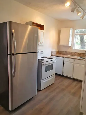 a white refrigerator freezer sitting in a kitchen