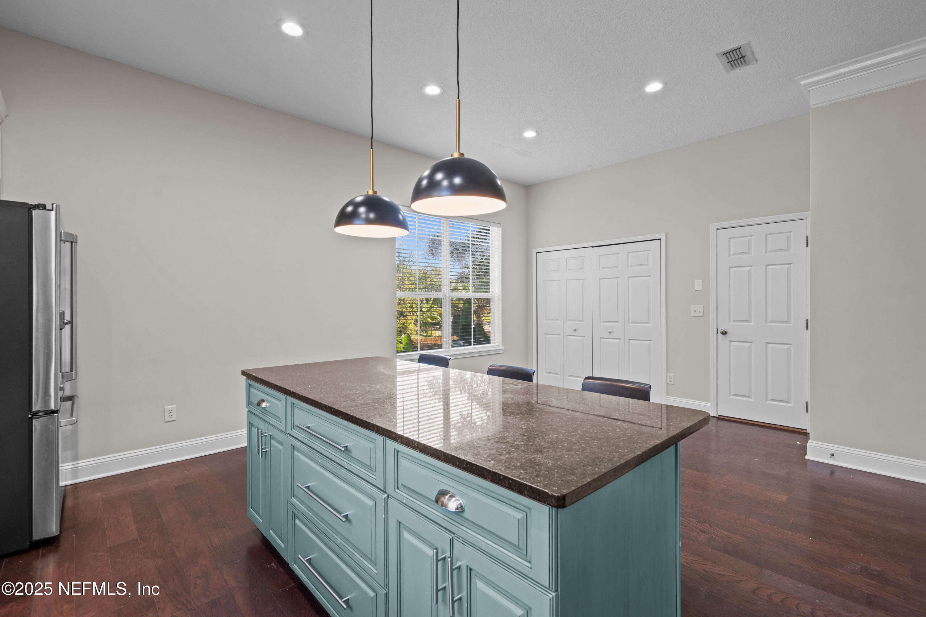 4187 Quail Drive St. Augustine, FL 32084 - Photo 13 of 38 a kitchen with granite countertop a sink cabinets and wooden floor