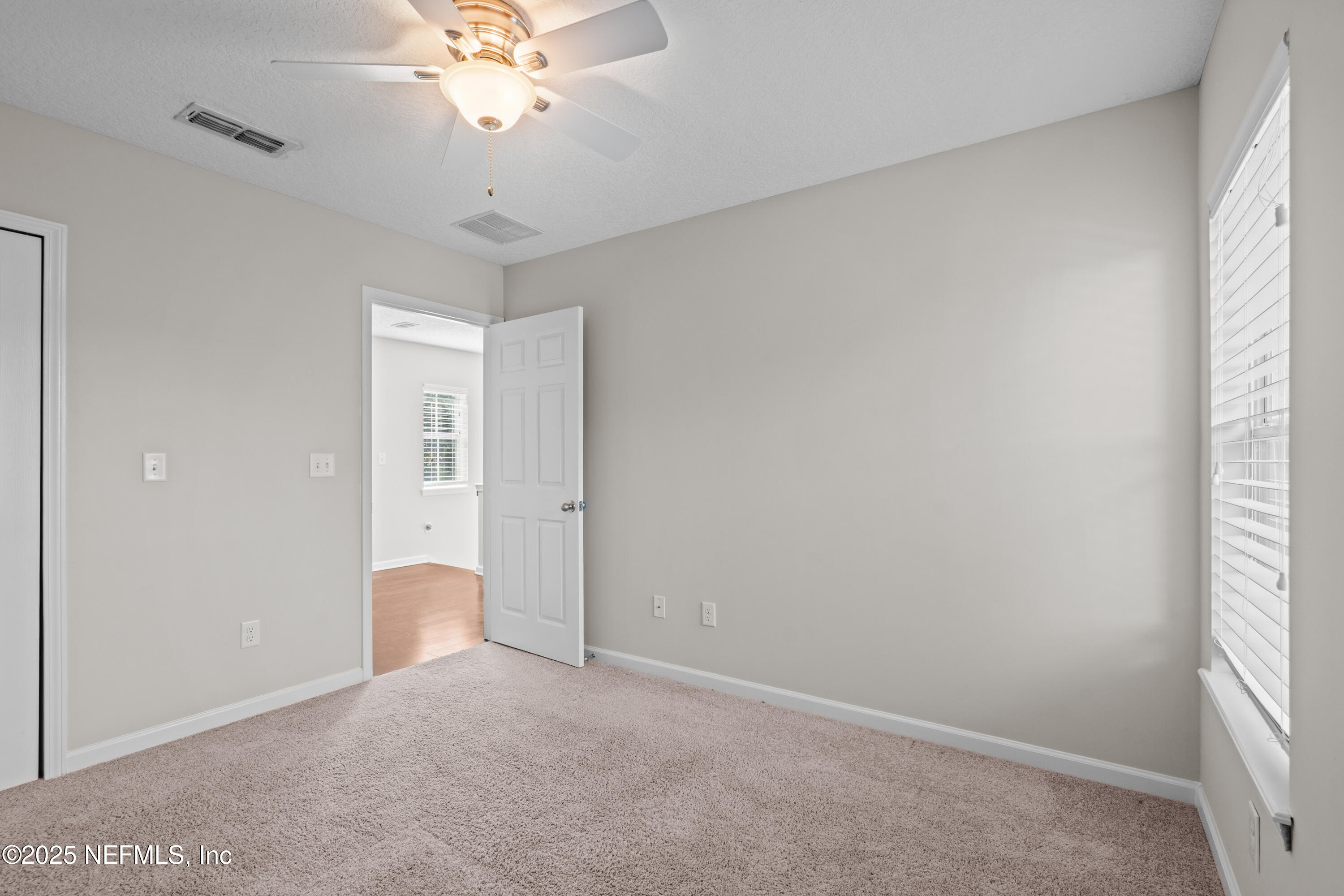 4187 Quail Drive St. Augustine, FL 32084 - Photo 18 of 38 wooden floor in an empty room with a window