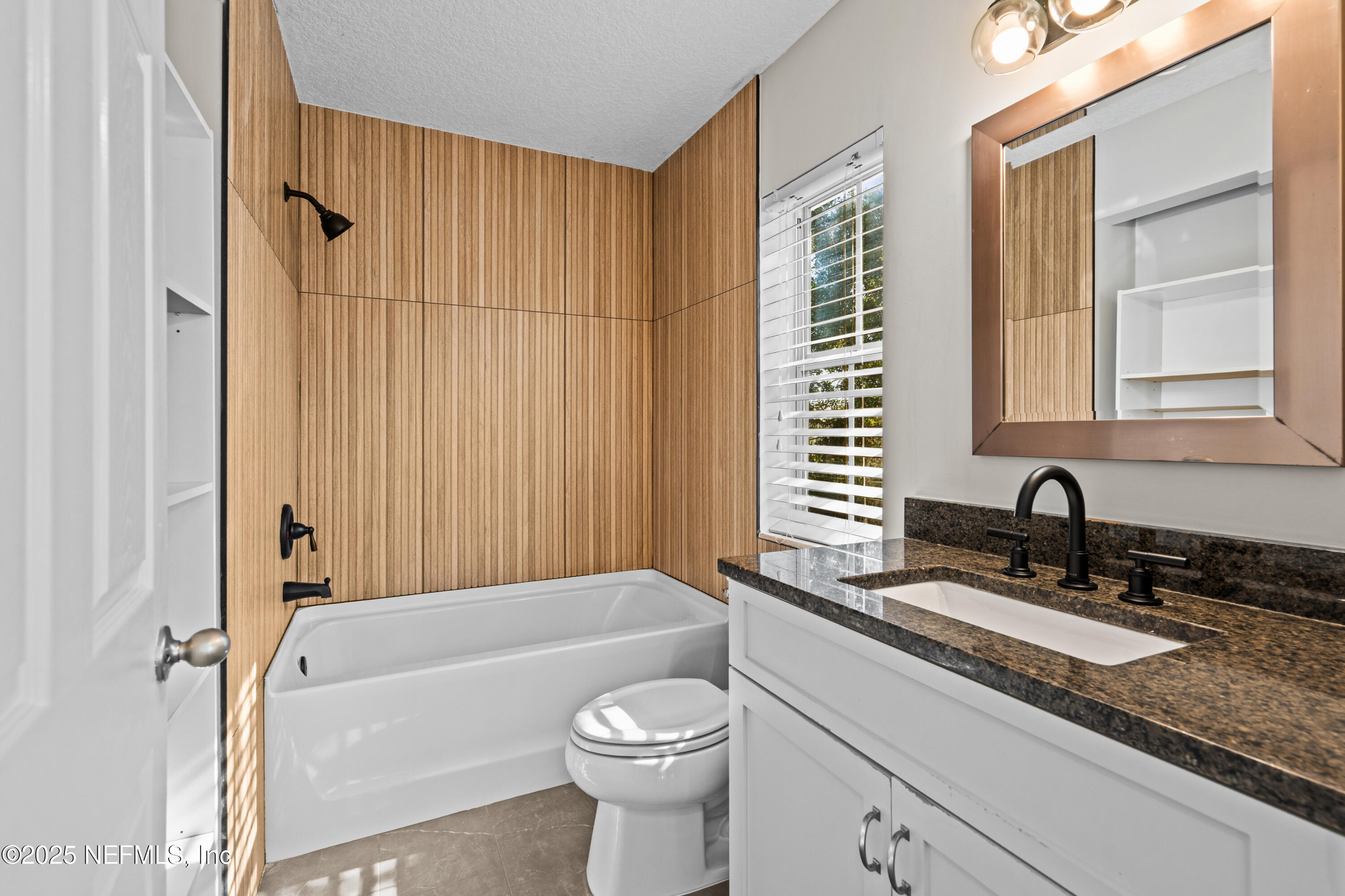 4187 Quail Drive St. Augustine, FL 32084 - Photo 19 of 38 a bathroom with a granite countertop sink toilet and shower