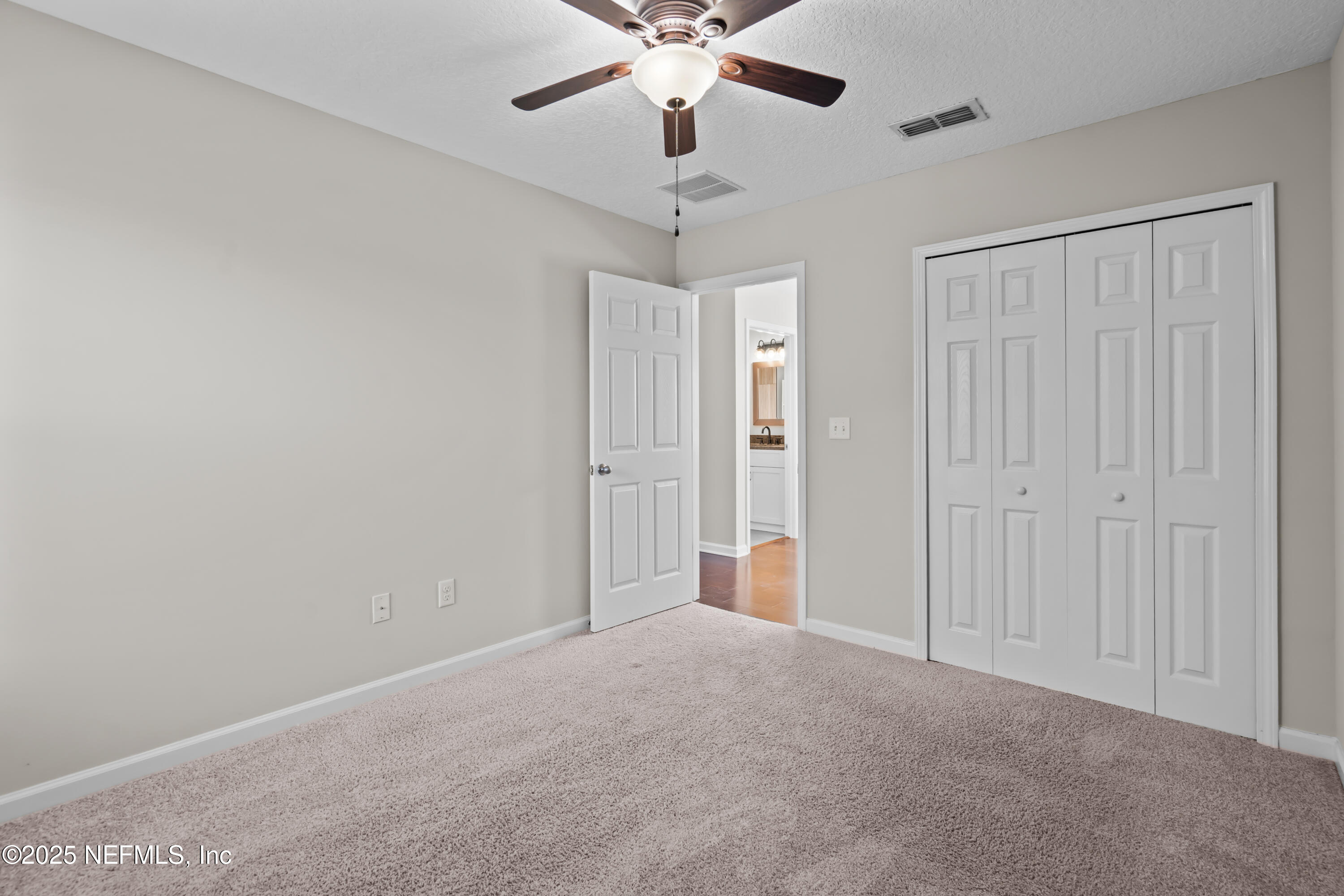 4187 Quail Drive St. Augustine, FL 32084 - Photo 21 of 38 a view of an empty room with a ceiling fan