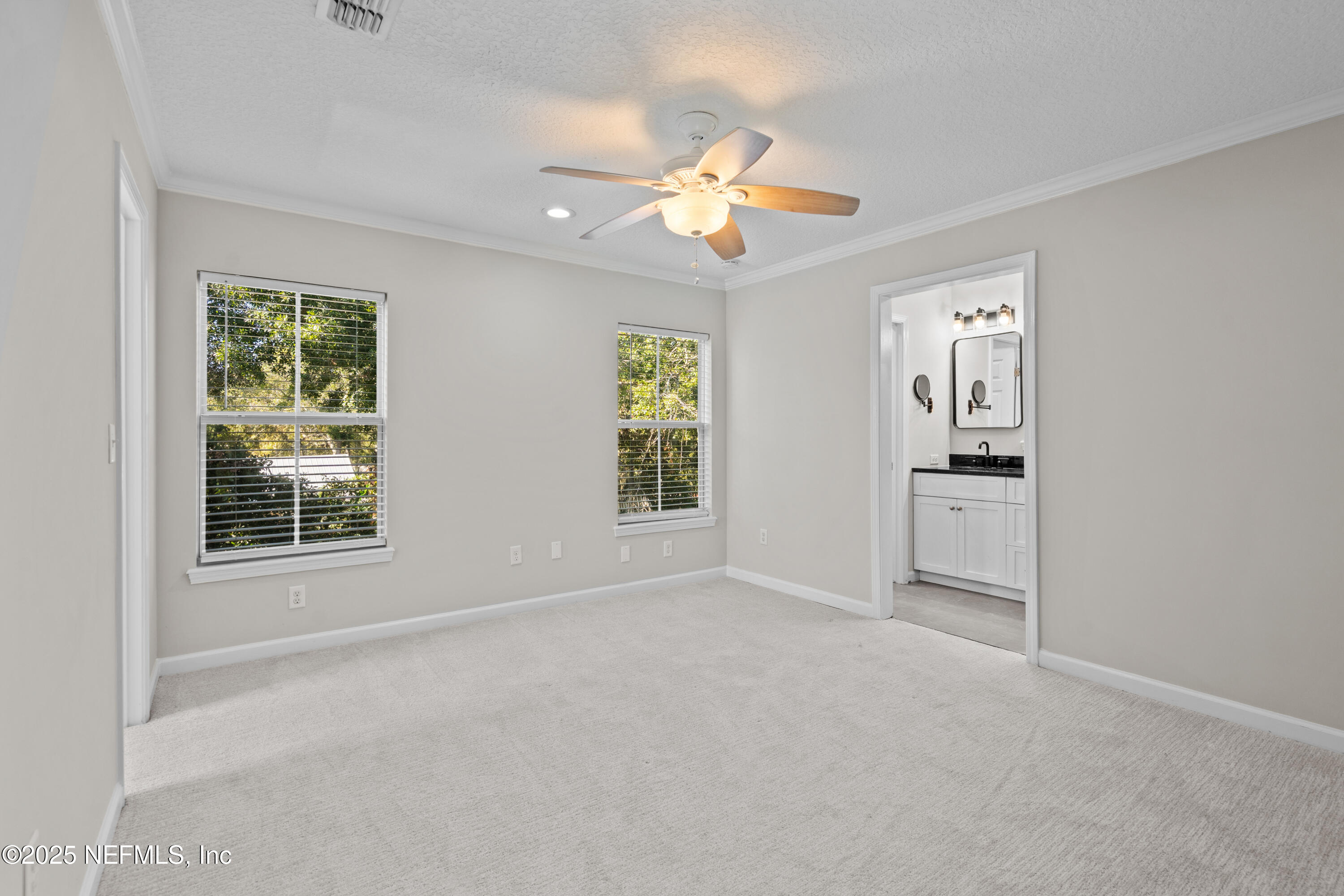 4187 Quail Drive St. Augustine, FL 32084 - Photo 22 of 38 an empty room with windows and ceiling fan
