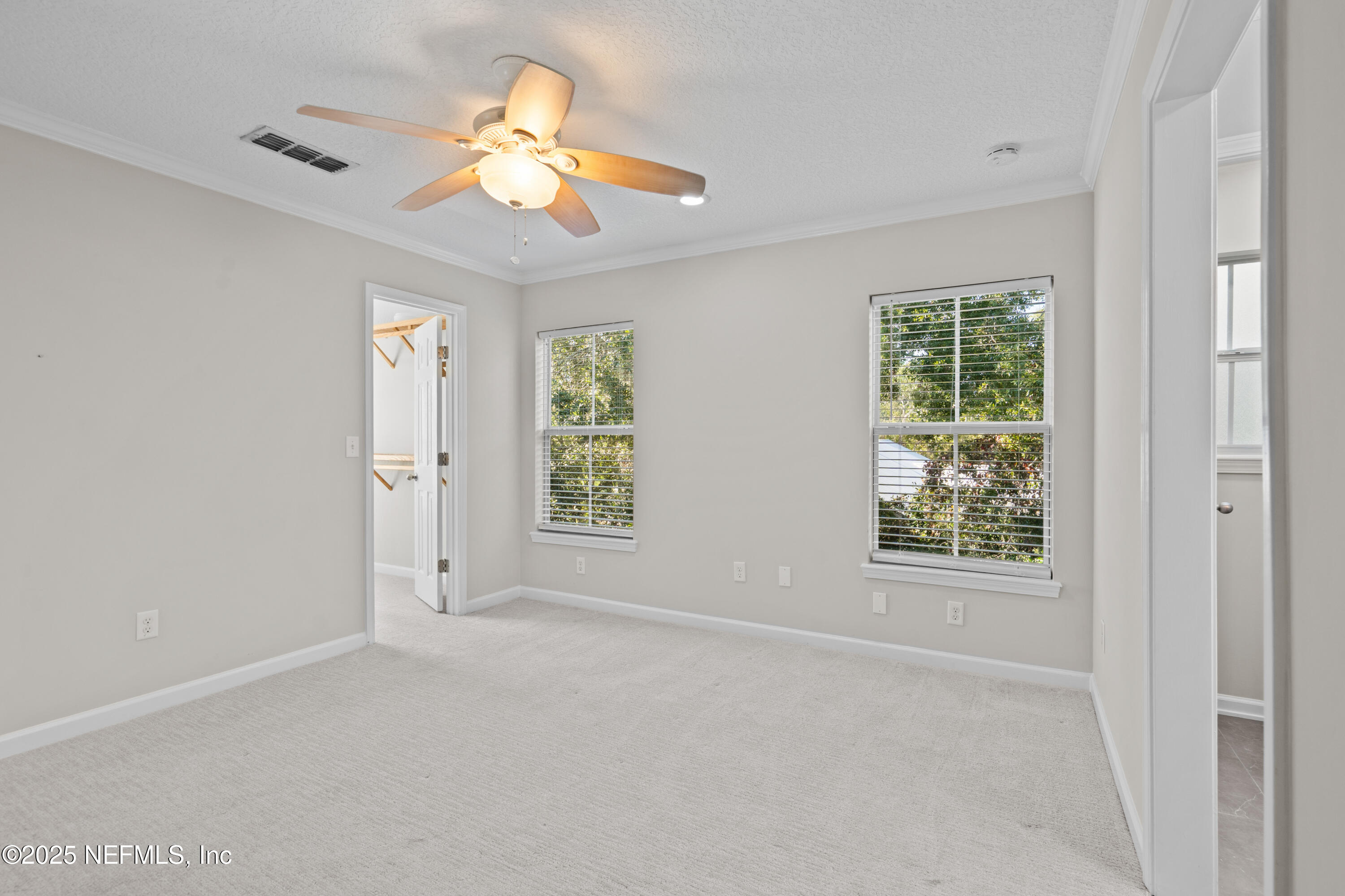 4187 Quail Drive St. Augustine, FL 32084 - Photo 23 of 38 en empty room with windows and chandelier fan