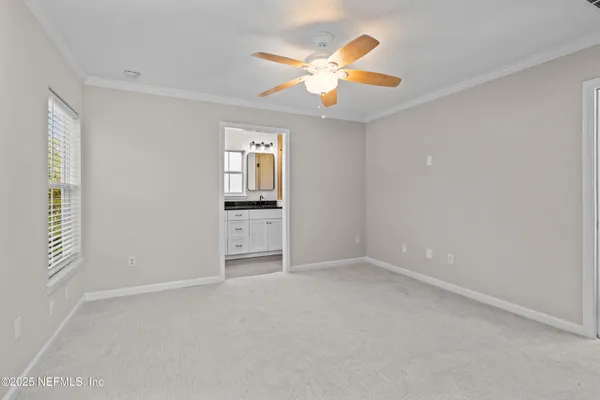an empty room with closet and windows