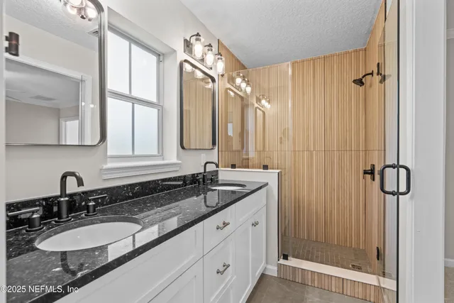 a bathroom with a granite countertop sink mirror and double