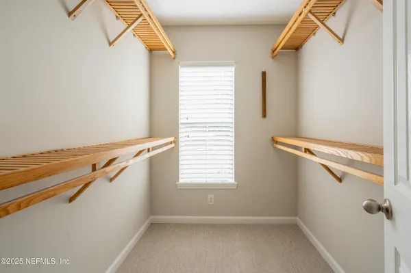 a view of a room with rack on the wall and a window