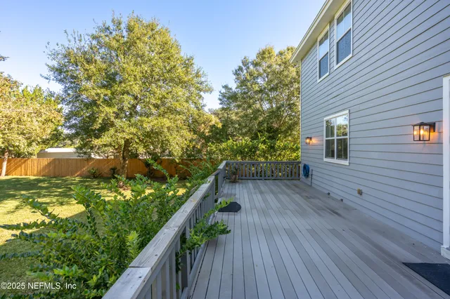 a view of balcony with wooden floor and fence