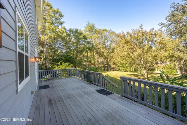 a view of balcony with wooden floor and fence
