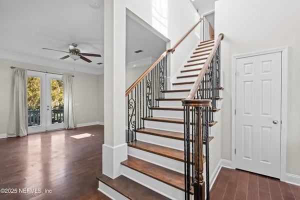 a view of entryway with wooden floor and stairs