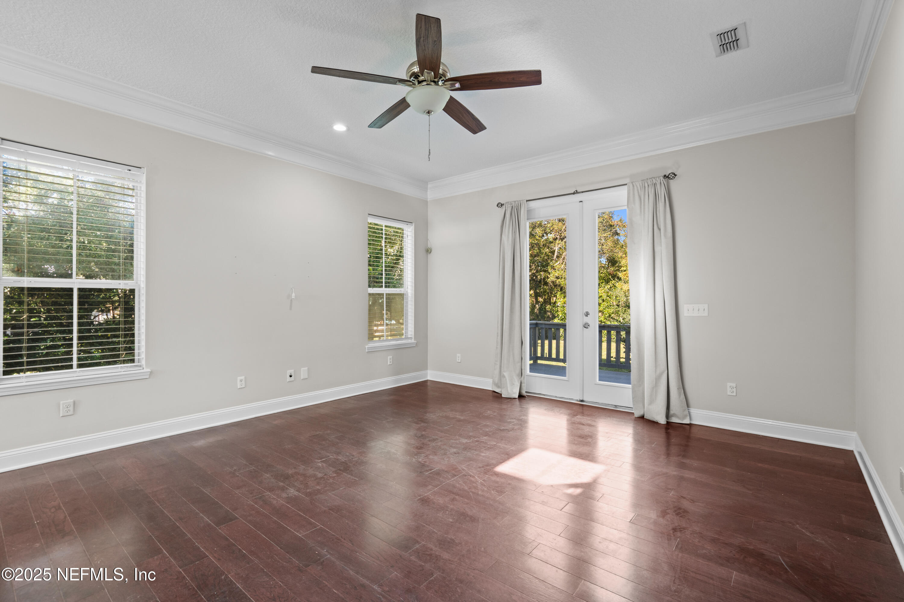4187 Quail Drive St. Augustine, FL 32084 - Photo 6 of 38 a view of an empty room with a window and wooden floor