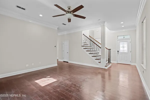 wooden floor in an empty room with a window