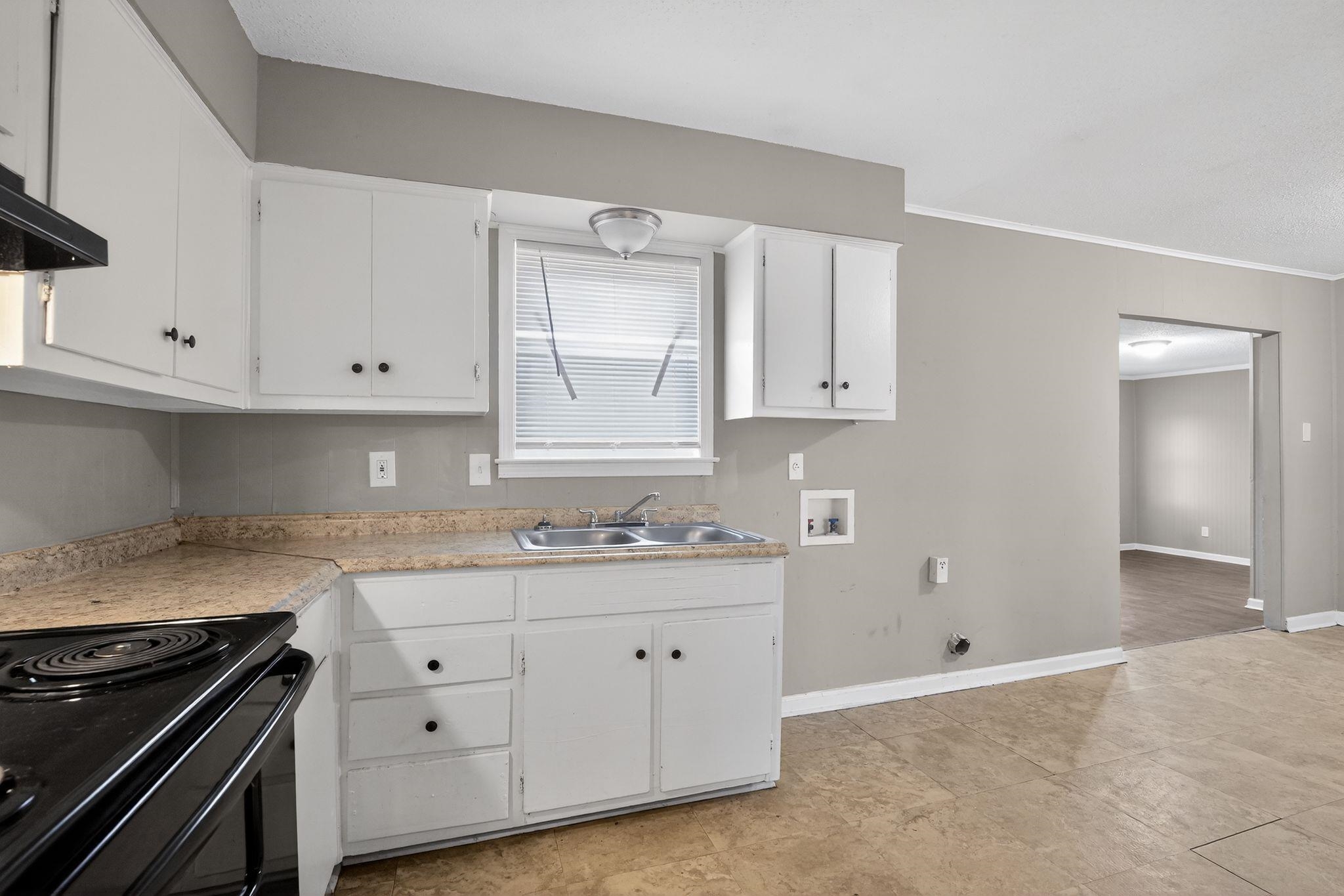 4314 Ford Road Memphis, TN 38109 - Photo 18 of 31 a kitchen with granite countertop white cabinets and stainless steel appliances