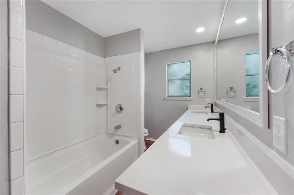 4005 Ridgebrook Drive Arlington, TX 76015 - Photo 17 of 18 Bathroom featuring a double vanity with white countertops, dual rectangular sinks, and matte black faucets