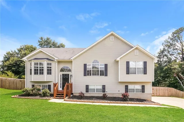 a front view of house with yard and green space