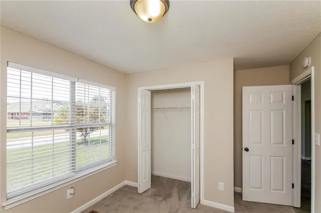 a view of a livingroom with wooden floor and window