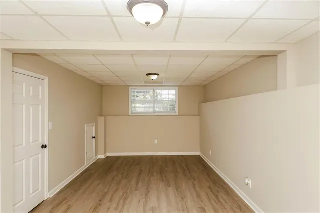 a view of a room with wooden floor and white walls