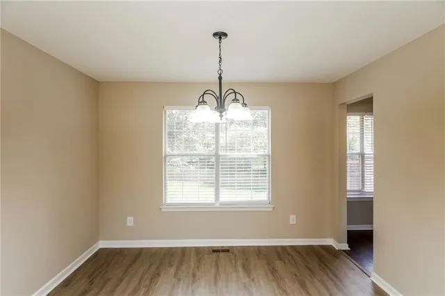 a view of wooden floor and windows in a room