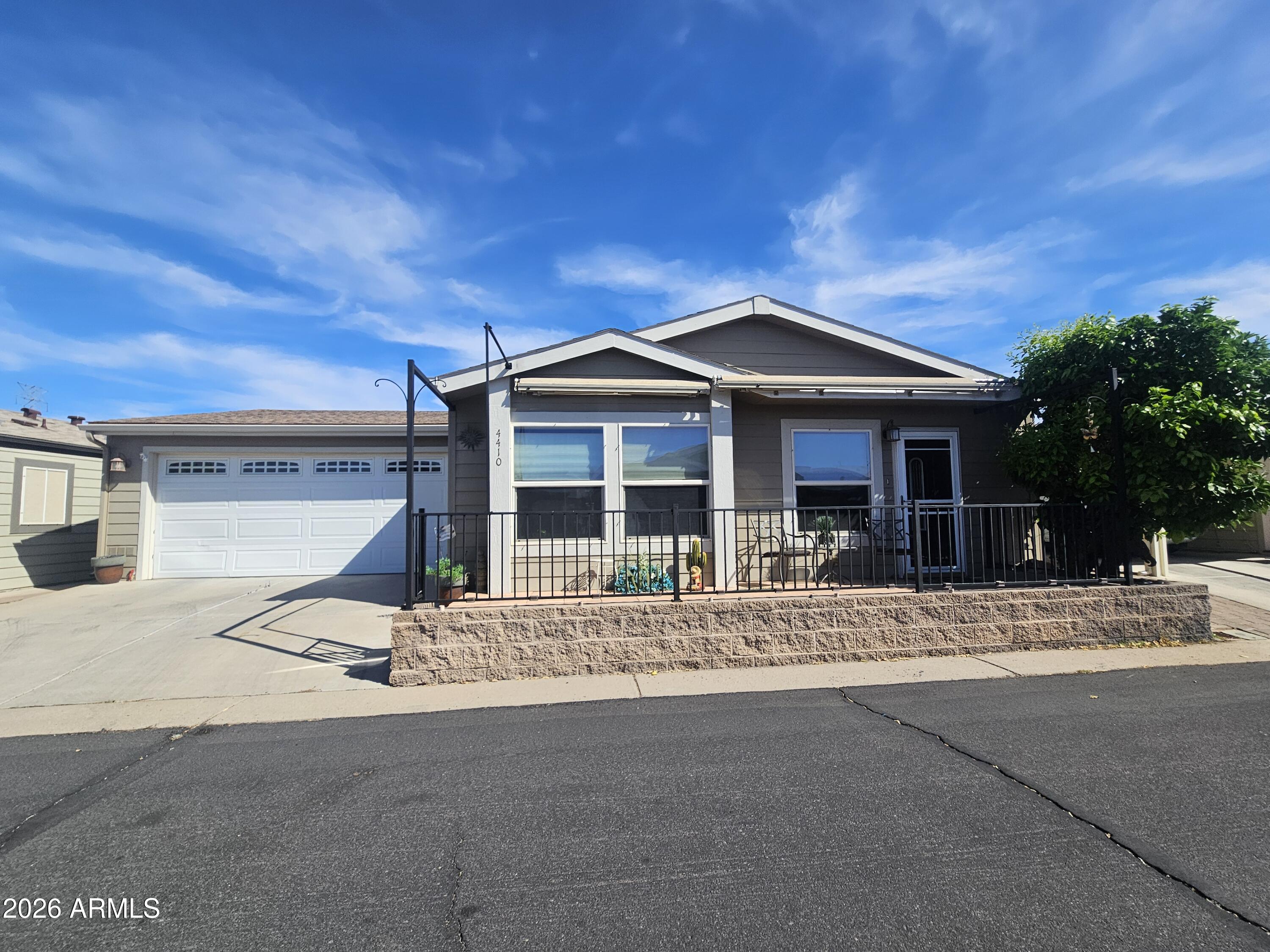 650 North Hawes Road, Unit 4410 Mesa, AZ 85207 - Photo 1 of 40 a front view of a house with a garden