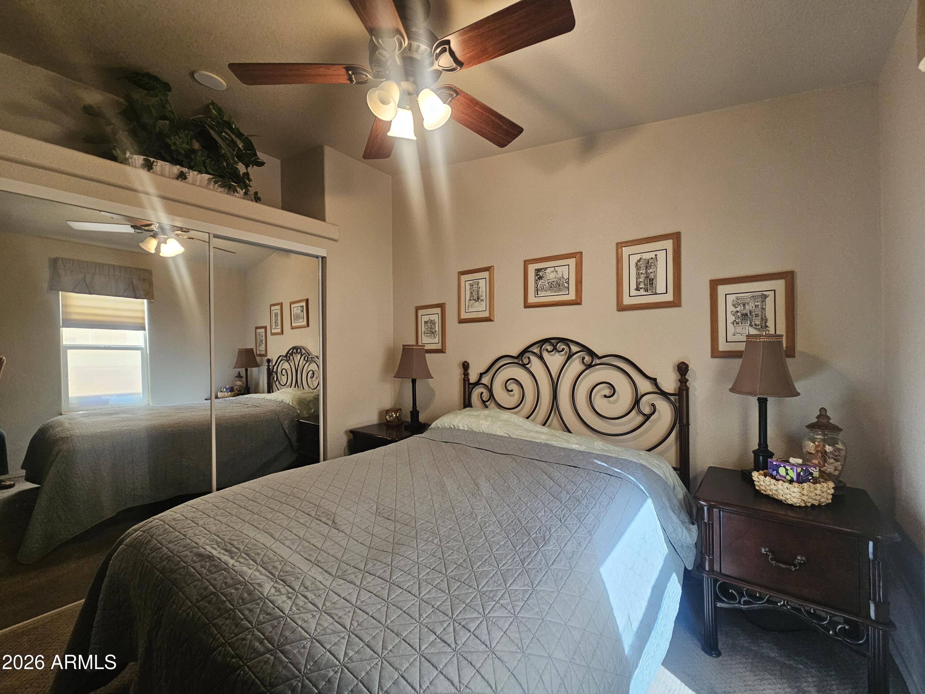 650 North Hawes Road, Unit 4410 Mesa, AZ 85207 - Photo 17 of 40 a bedroom with a bed and a chandelier